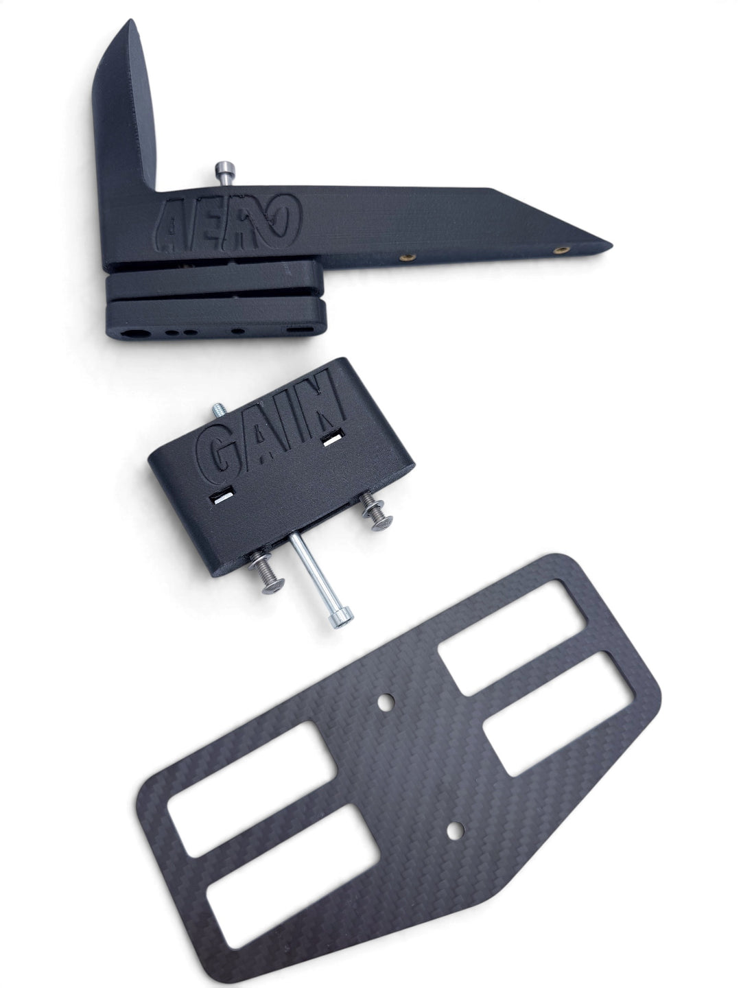AeroGain Aero BTA spacer parts laid out: nose-cone top with height spacers, cross-bolted spacer body with its bolts, and the 3 mm carbon fibre plate
