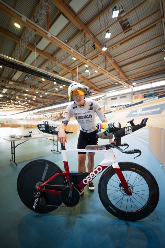 Rider with the bike at the trackside between runs