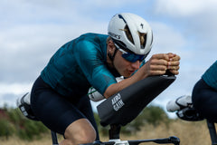 Rider in the aero position on the AeroGain Aero Cockpit, forearms closed together on the one-piece surface