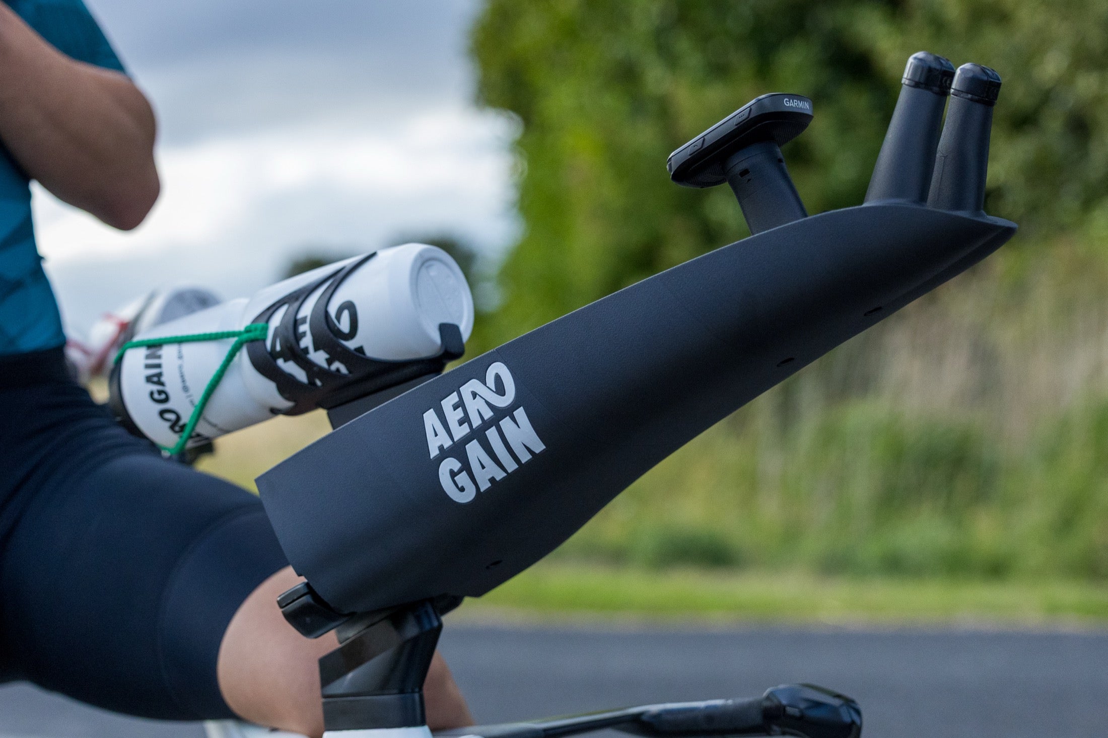 A rider's forearm resting in the cup of the Custom Aero Cockpit PRO, on the road